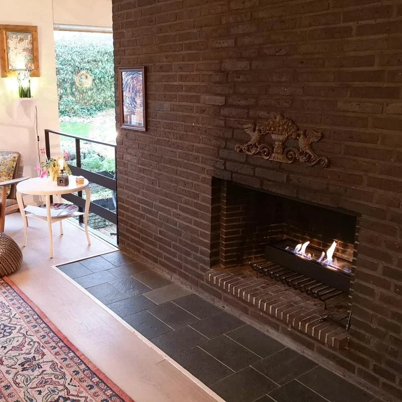 Bioethanol burner insert lit inside a real customer's brick fireplace, genuine customer photo